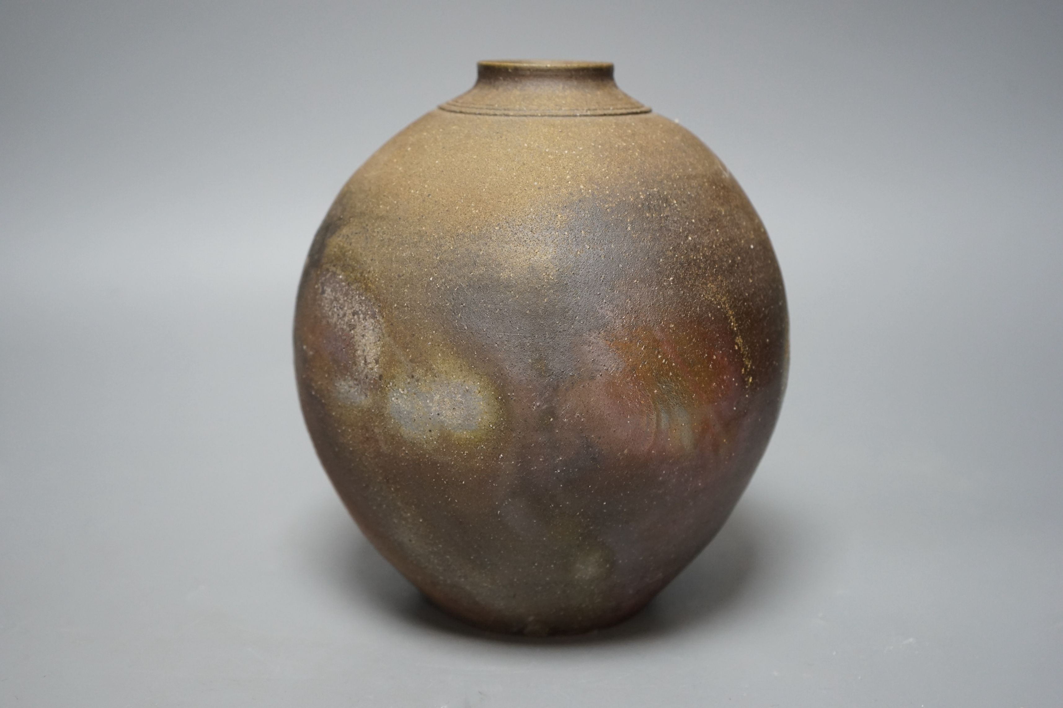 Japanese studio pottery: a boxed black glaze stoneware unomi tea bowl, with impressed mark, together with a ovoid vase, marked, 21cm tall